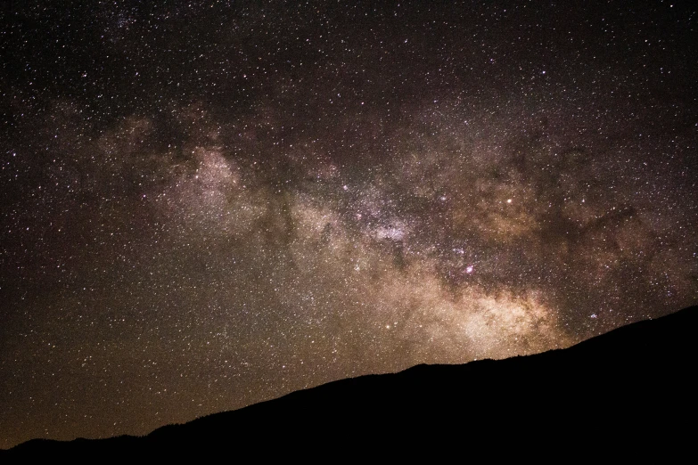 a mountain that has a sky full of stars