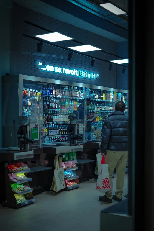 a man walking through a store filled with food and other items