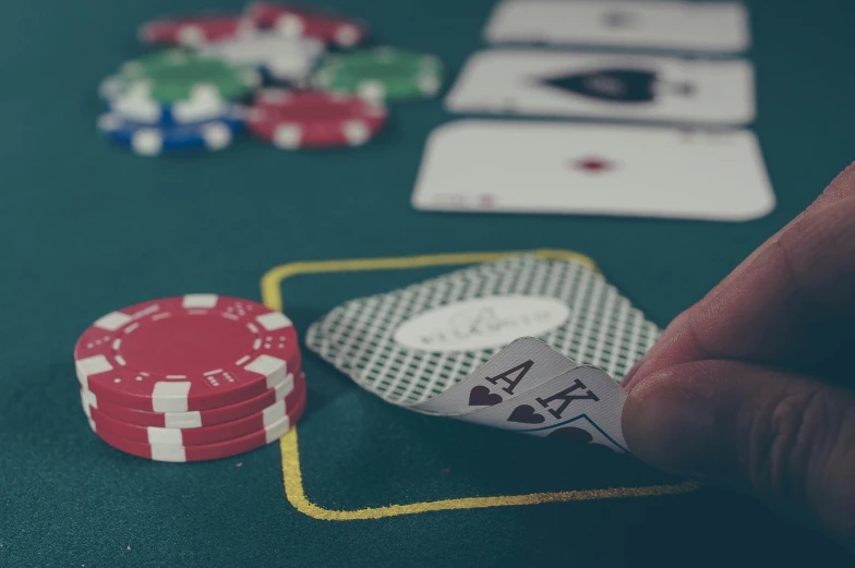 poker chips and playing cards spread out on a table