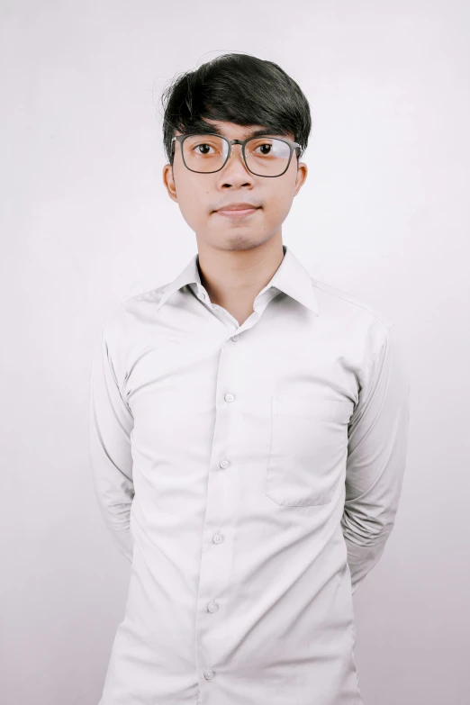 a male in a white shirt and some glasses