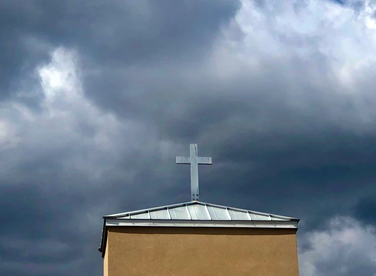 a church steeple has a cross at the top