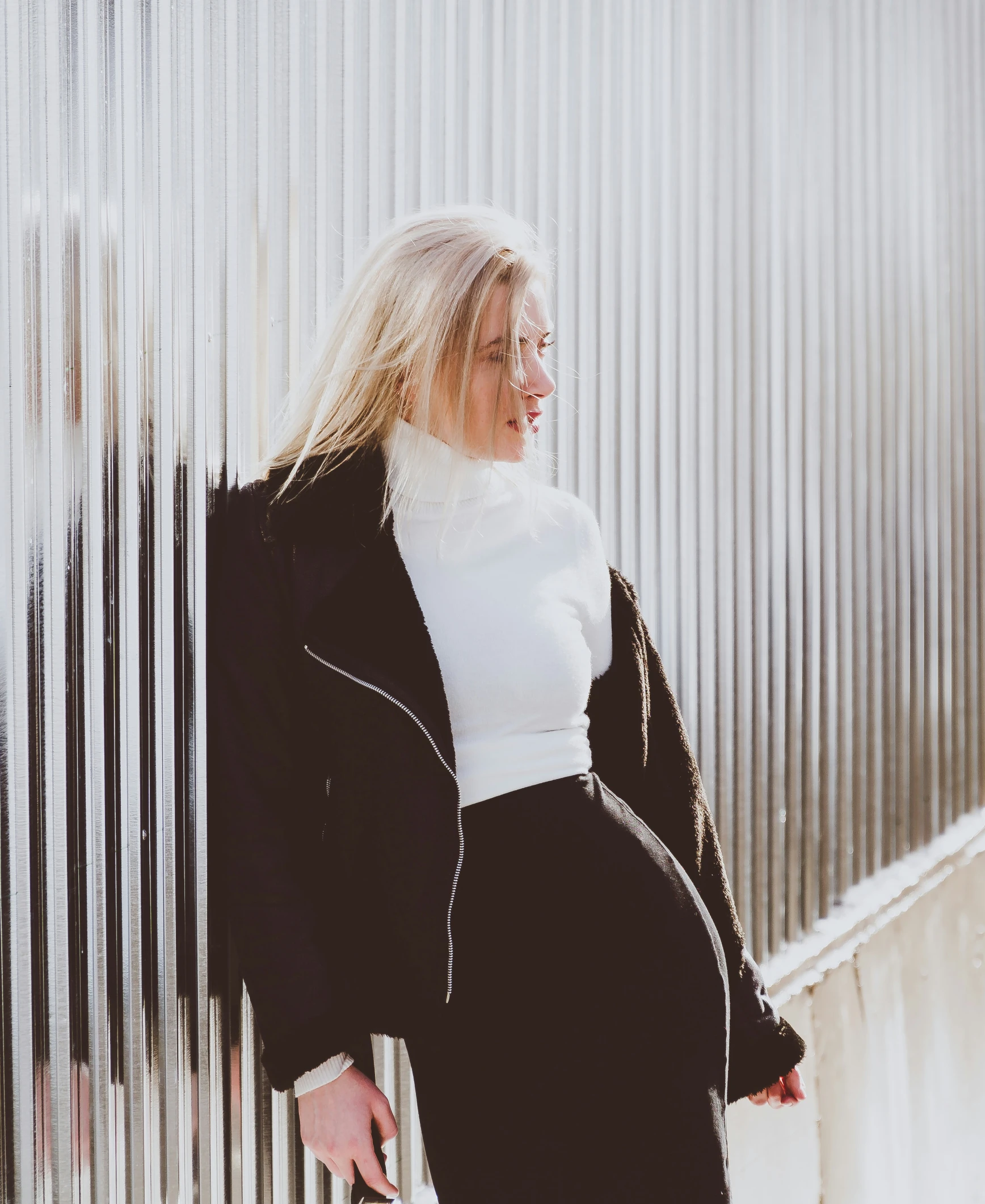 a woman standing in front of a metal building