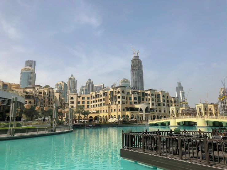 an outdoor restaurant with an expansive blue lagoon next to the city