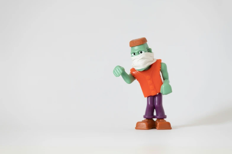 a figurine wearing a surgical bandage is posing for a pograph