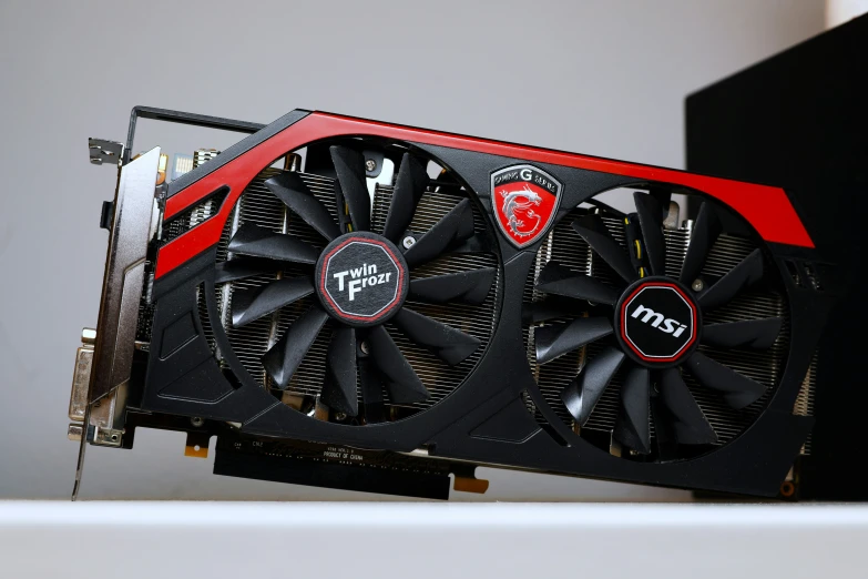 a red and black graphics card sits on top of the other