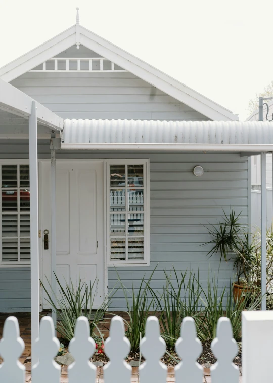 a white house with a nice picket fence