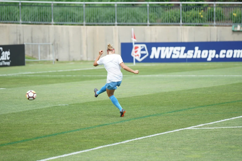 soccer player running to kick the ball towards goal