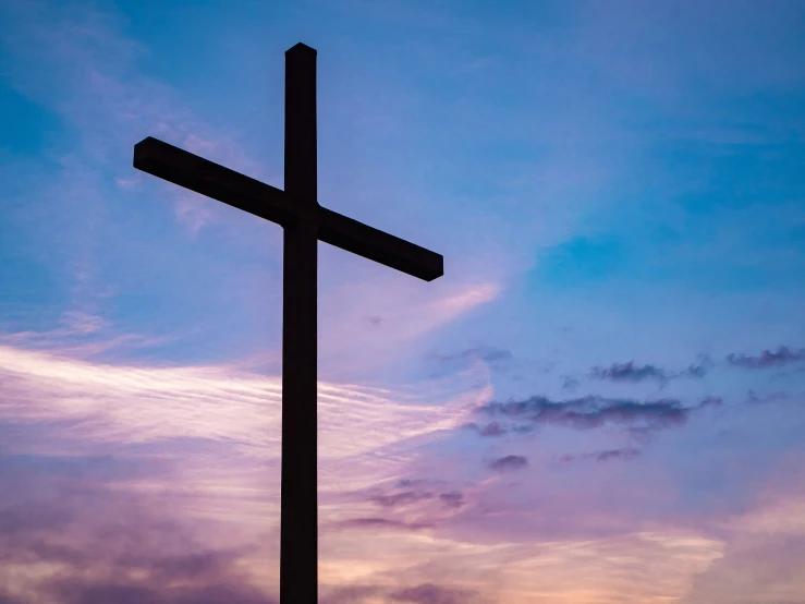 the cross and clouds are purple and blue