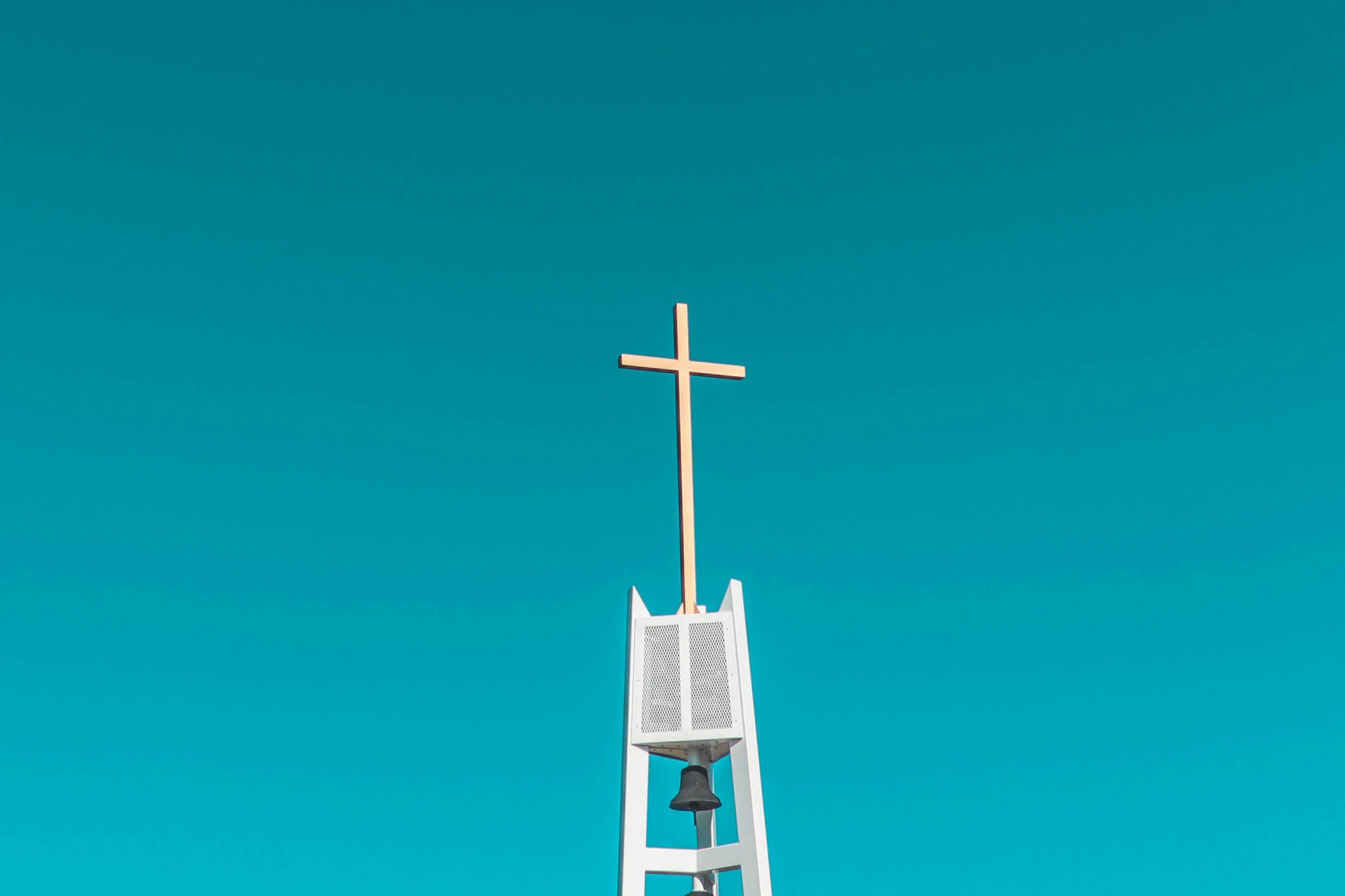 a large cross is placed on top of a tower