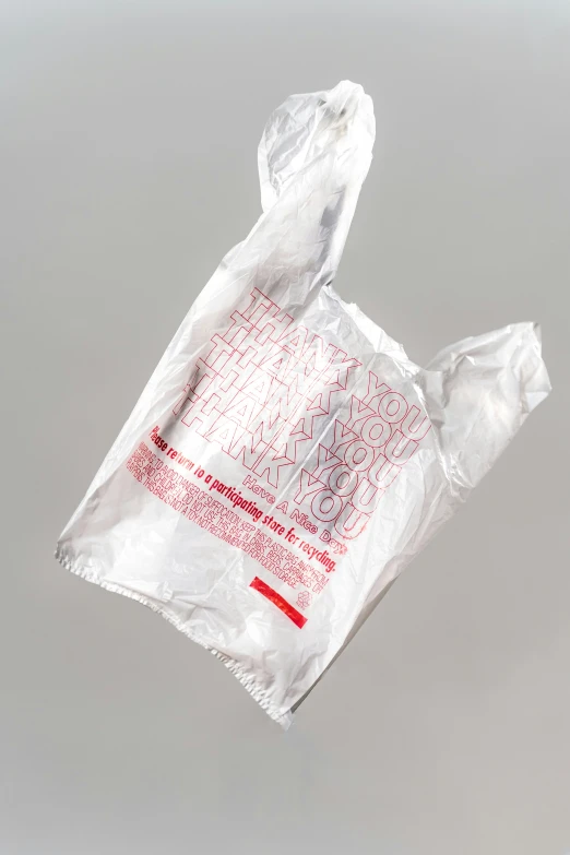 a plastic bag suspended in the air from a string