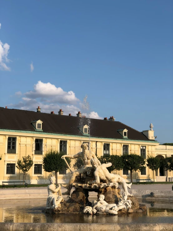 fountain in front of large yellow building near courtyard