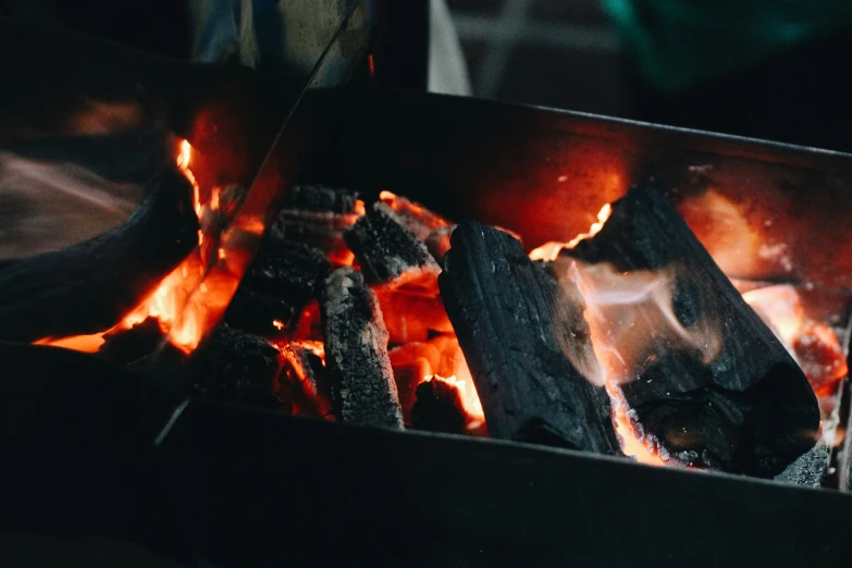 an open box of food is being cooked over a grill