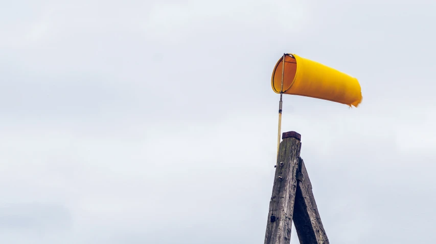 a yellow umbrella being lowered into the air