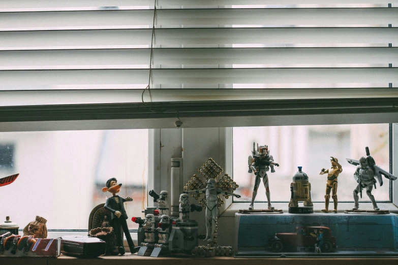 a window pane filled with toy figurines next to windows