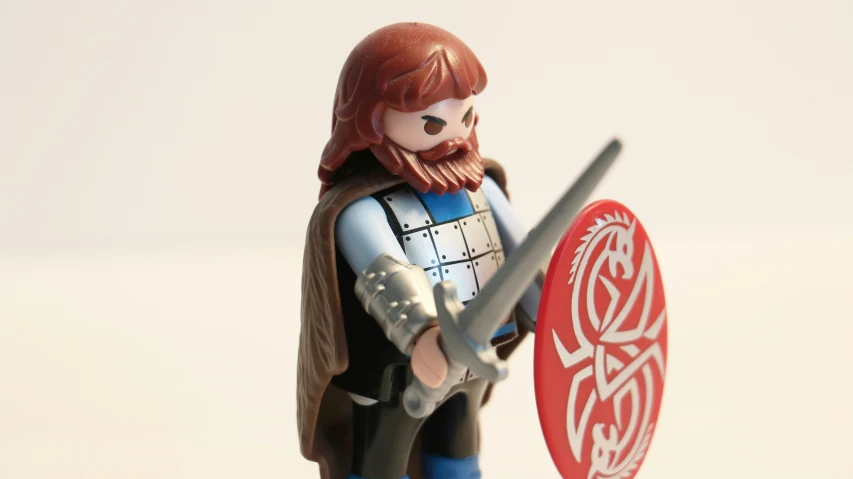 a person that is holding a sword and shield