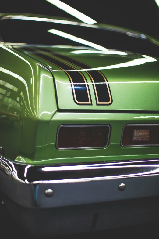 the side of an old green sports car