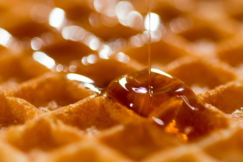 some kind of liquid is falling out of some waffles