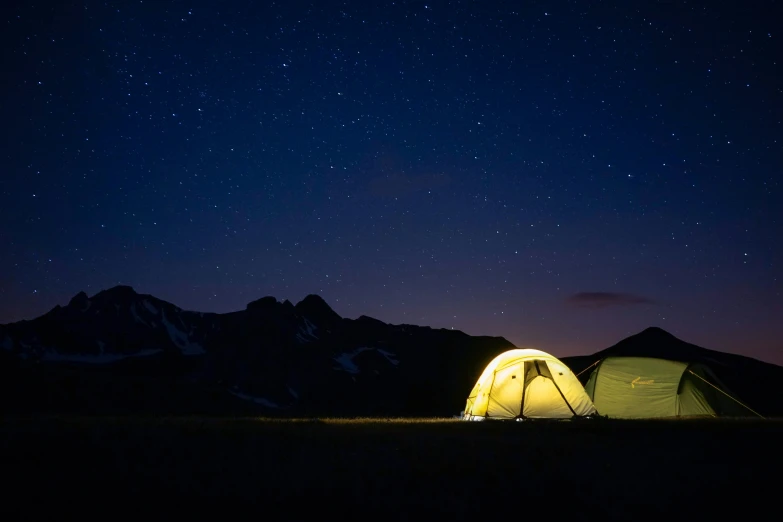 a tent set up in the middle of the night