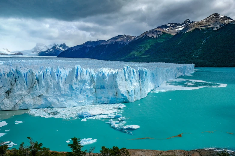the glacier walls are mostly submerged in turquoise water