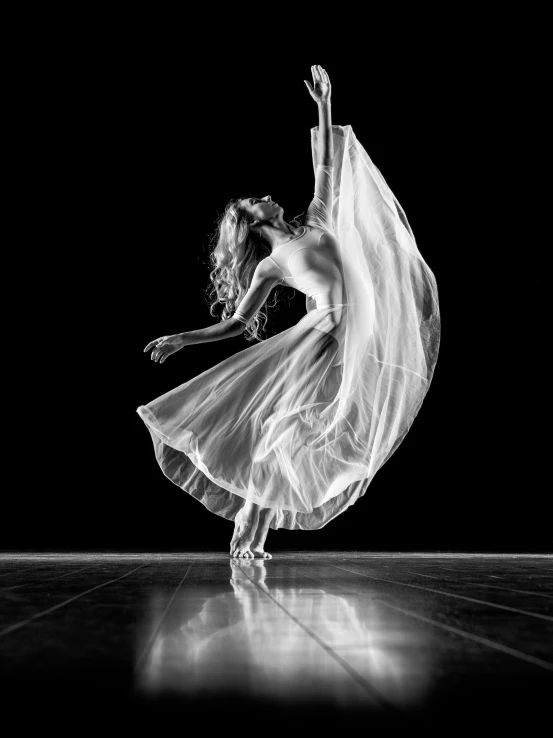 a woman dancing in white dress on dance floor