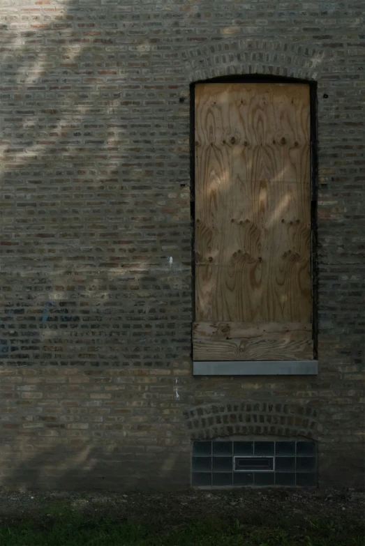 an open wooden door on a brick building