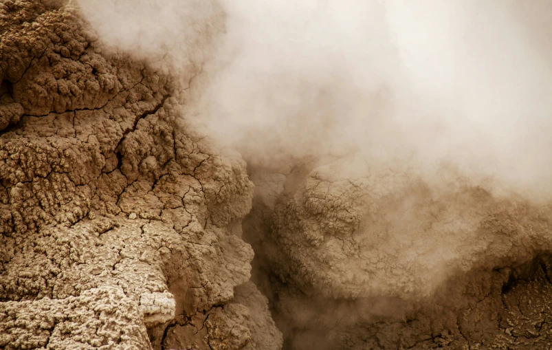 smoke is pouring out of the rocks in a vent