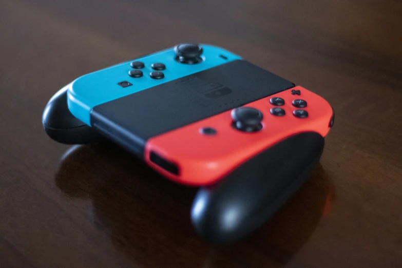 two controllers sitting on top of a table