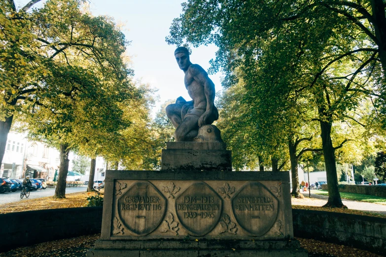 a statue is sitting in the middle of a park