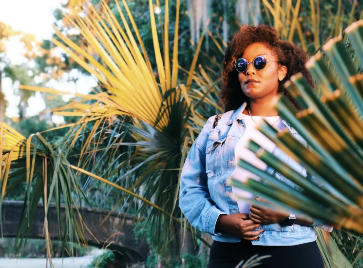 a woman with sunglasses in the jungle