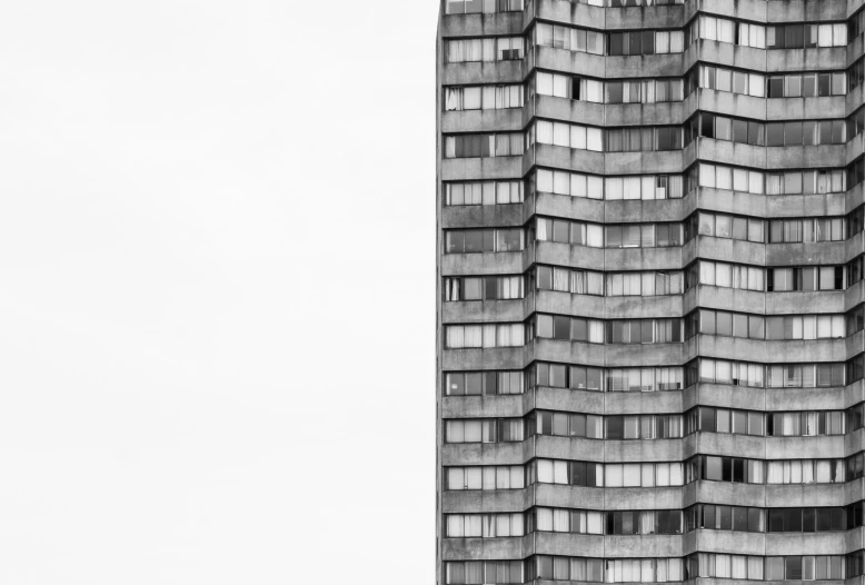 a large building that is standing tall against a white sky