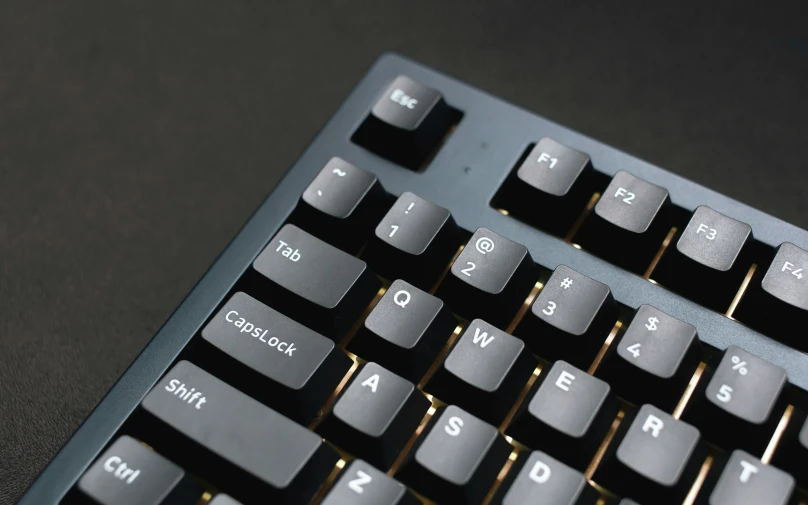 an old style computer keyboard with dark keys