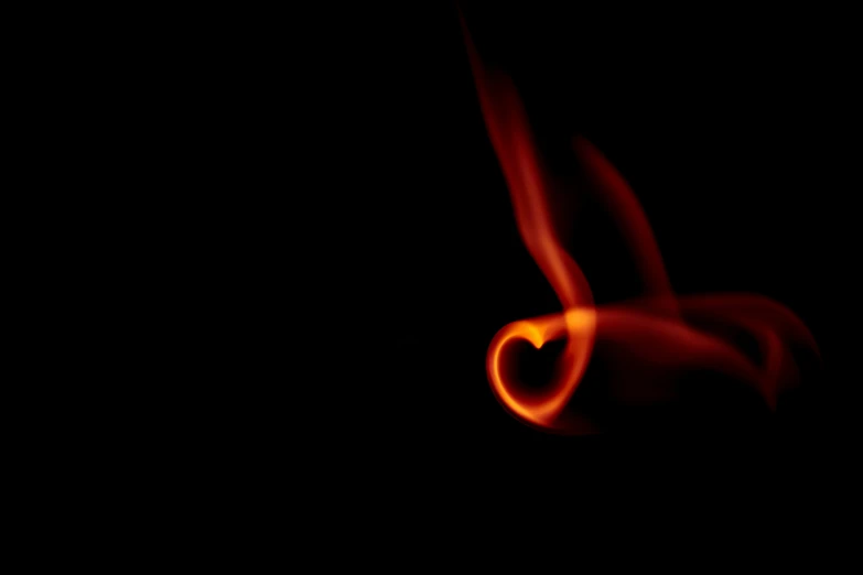 a red heart shaped object with some fire