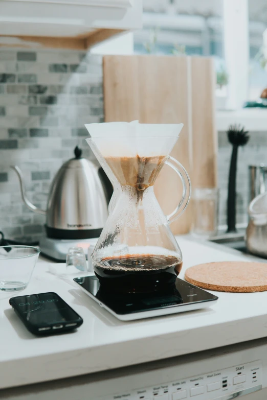 coffee pouring in a glass kettle on top of a kitchen counter