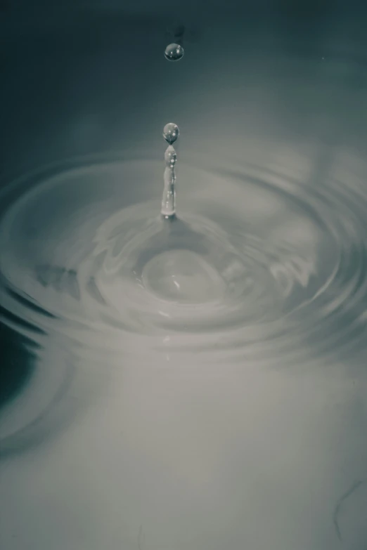 water is flowing from above a small drop