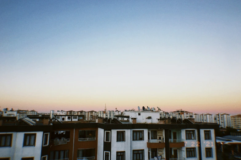 a city skyline with tall buildings and apartments in the background