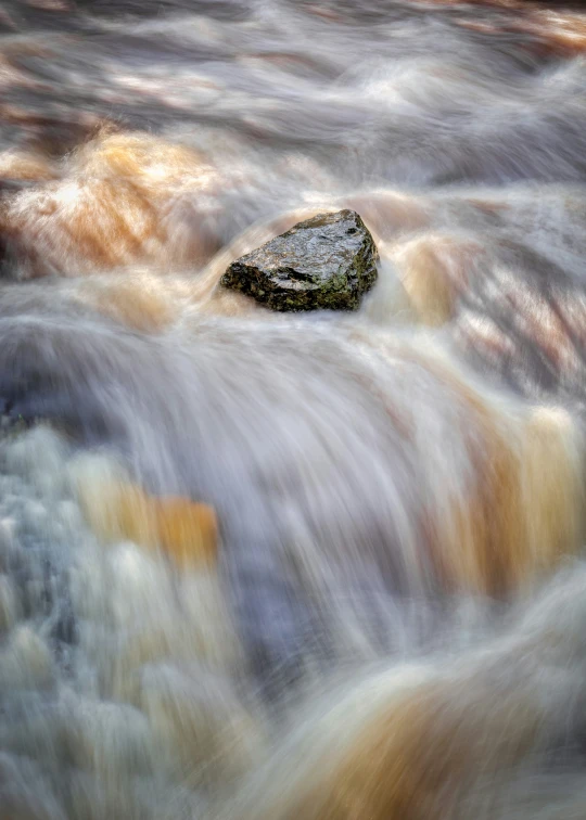 a single rock floating in some water