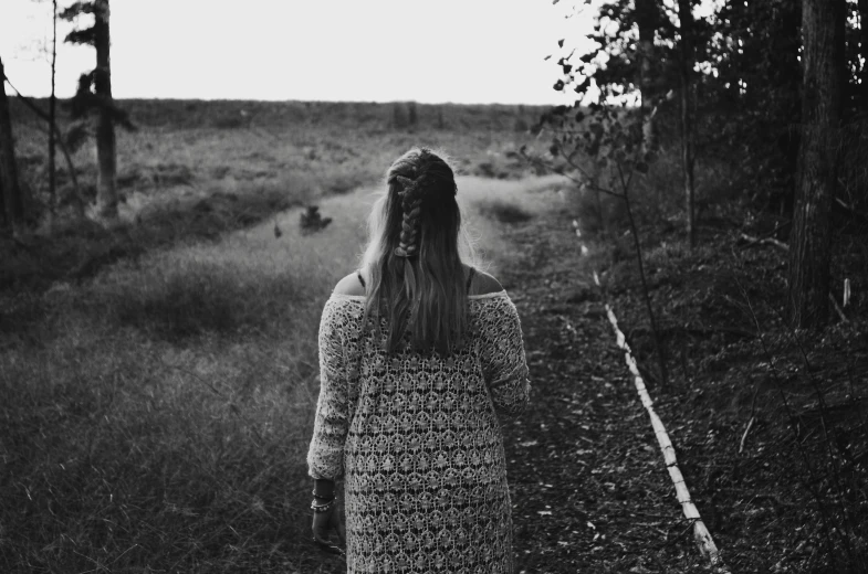 woman walking in a long sleeved dress in black and white