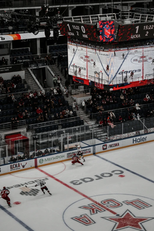 the red wings and maple leafs playing on an ice rink