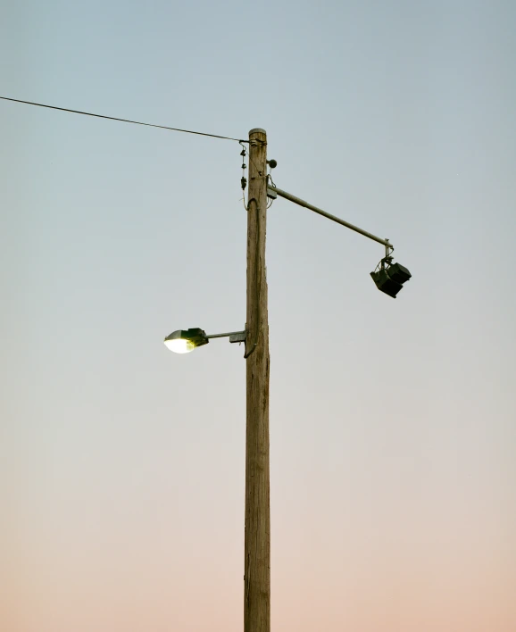 an electric pole with an overhead light attached