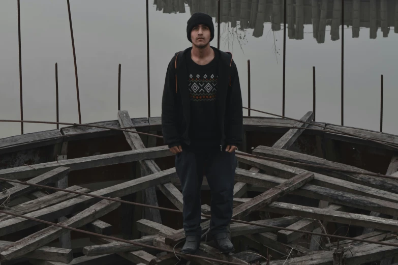 a man standing on top of an over wooden boat