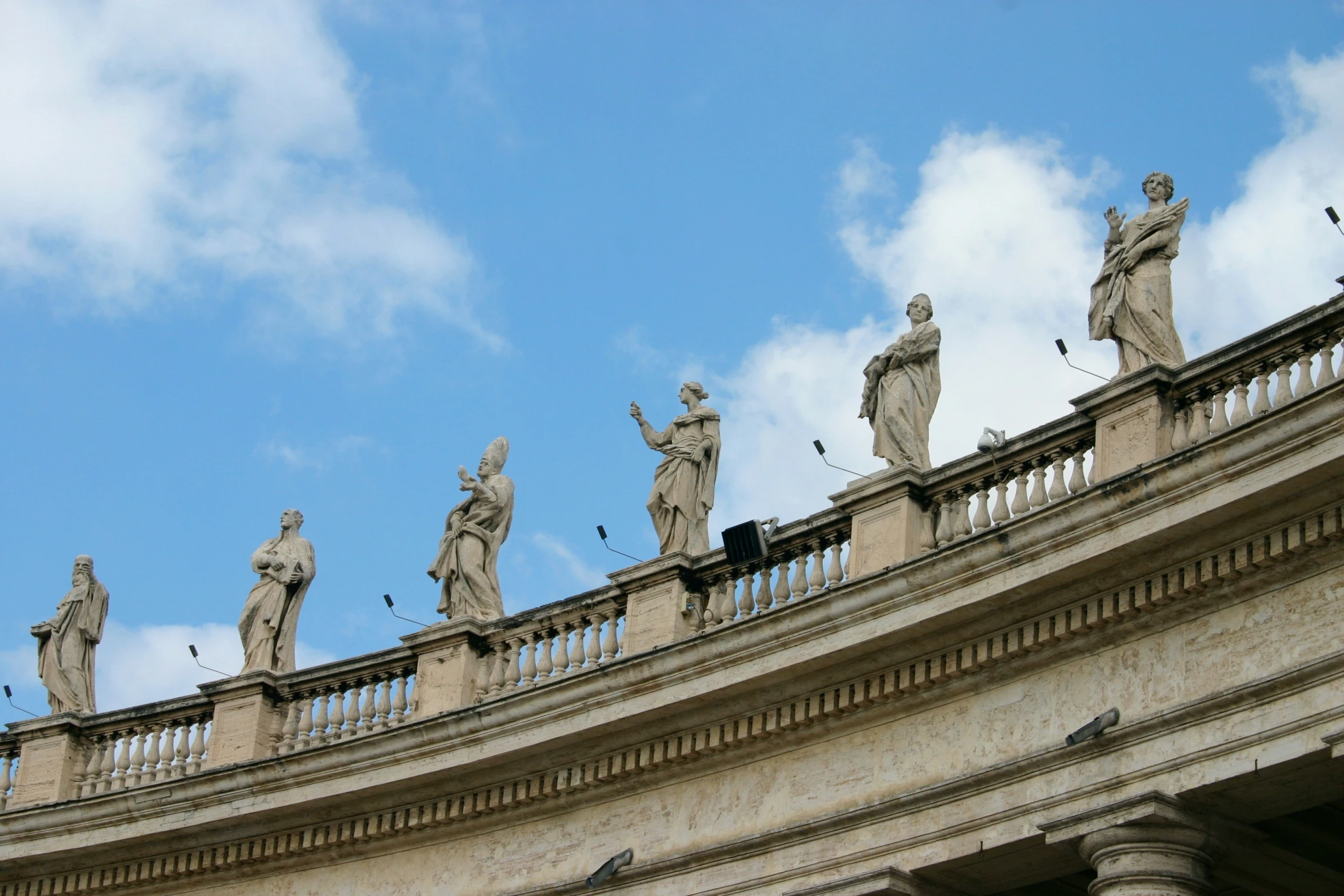 a group of statues sitting on top of a building