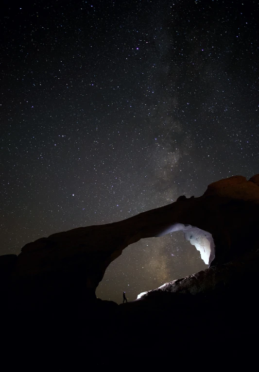 a mountain under a night sky filled with stars