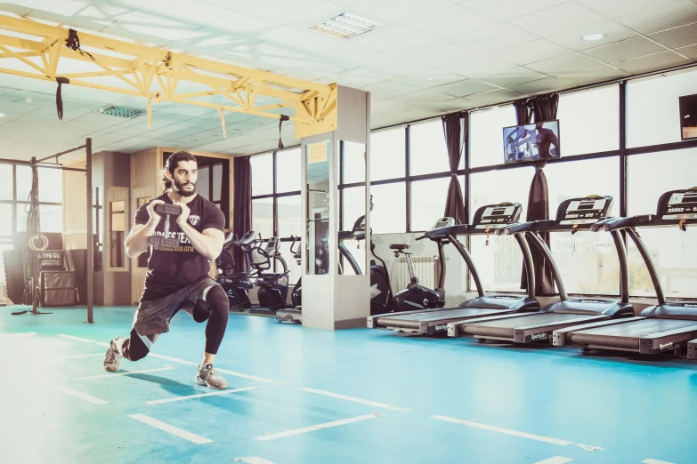 a man running on a blue tile floor in the gym