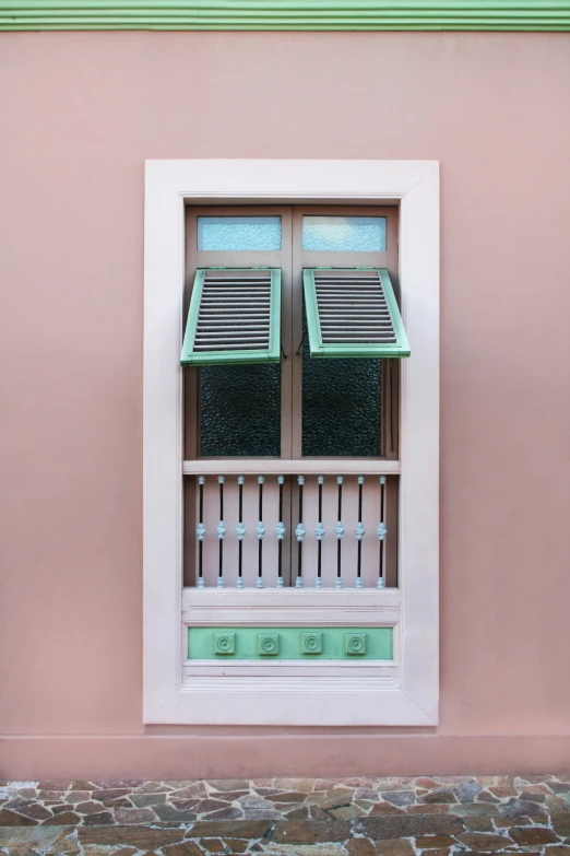 an empty window and shutters in a pink building