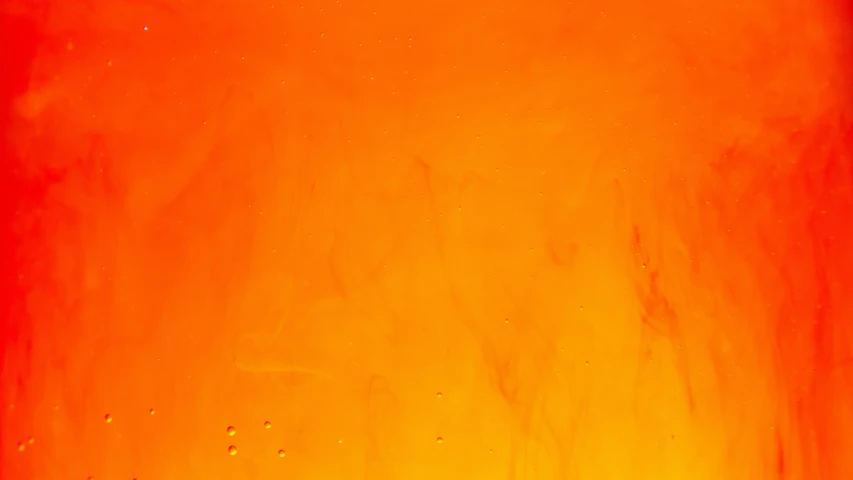 a bright orange colored liquid pours from the top