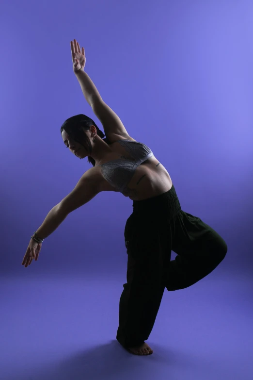 a woman is doing yoga and stretching