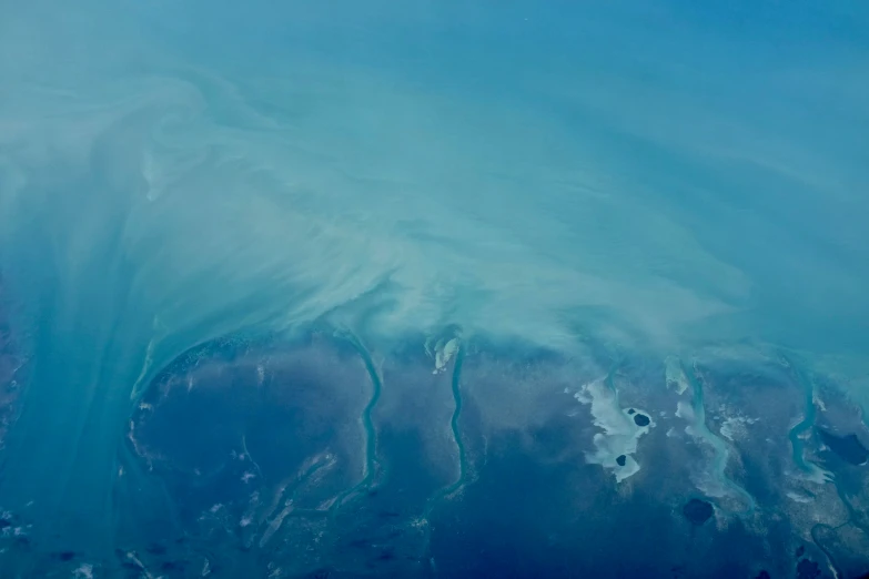 a large body of blue water with a pattern on it