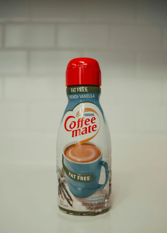 a bottle of coffee mate sitting on top of a table