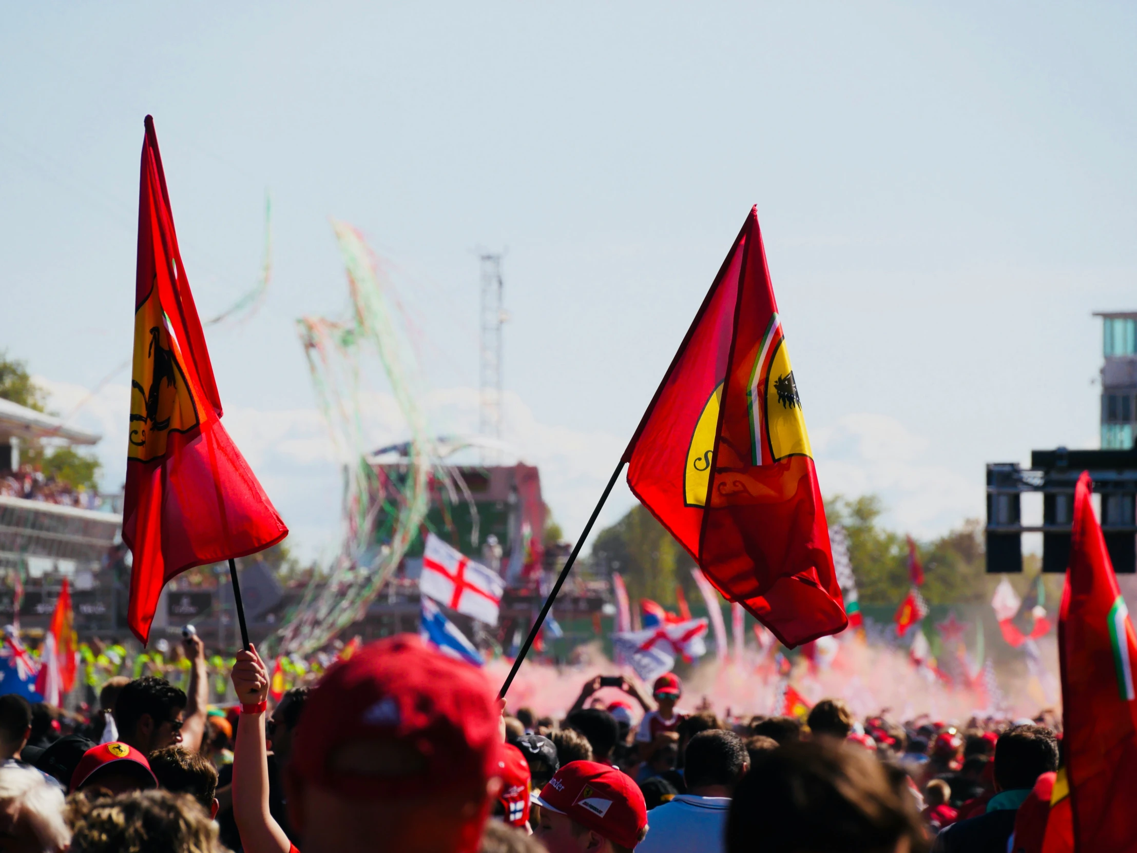 a crowd holds up flags in the air