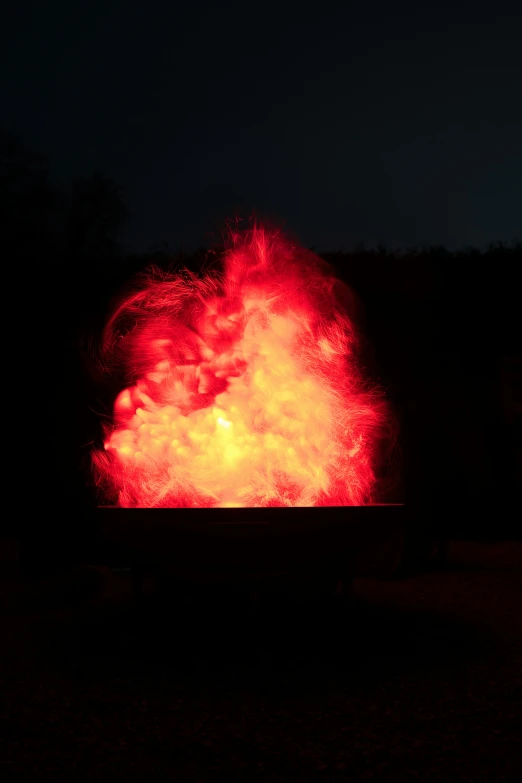 a group of firework in the dark lit up with bright red and yellow